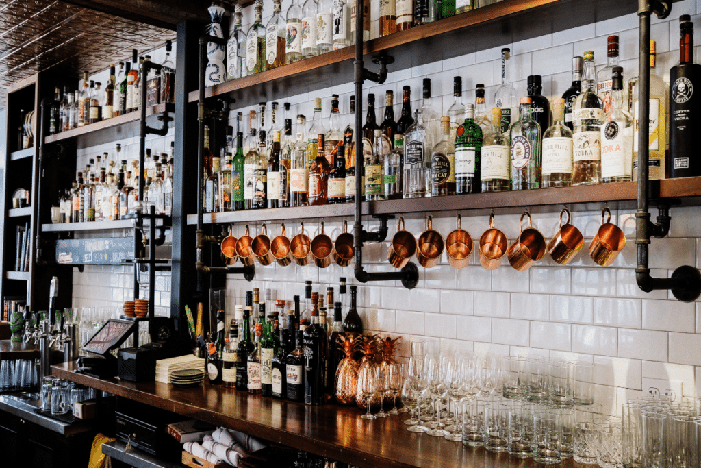 A speakeasy bar filled with liquor, glasses and more