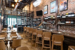 Interiors, bar, and wine selection at Helen Greek Food & Wine in Houston