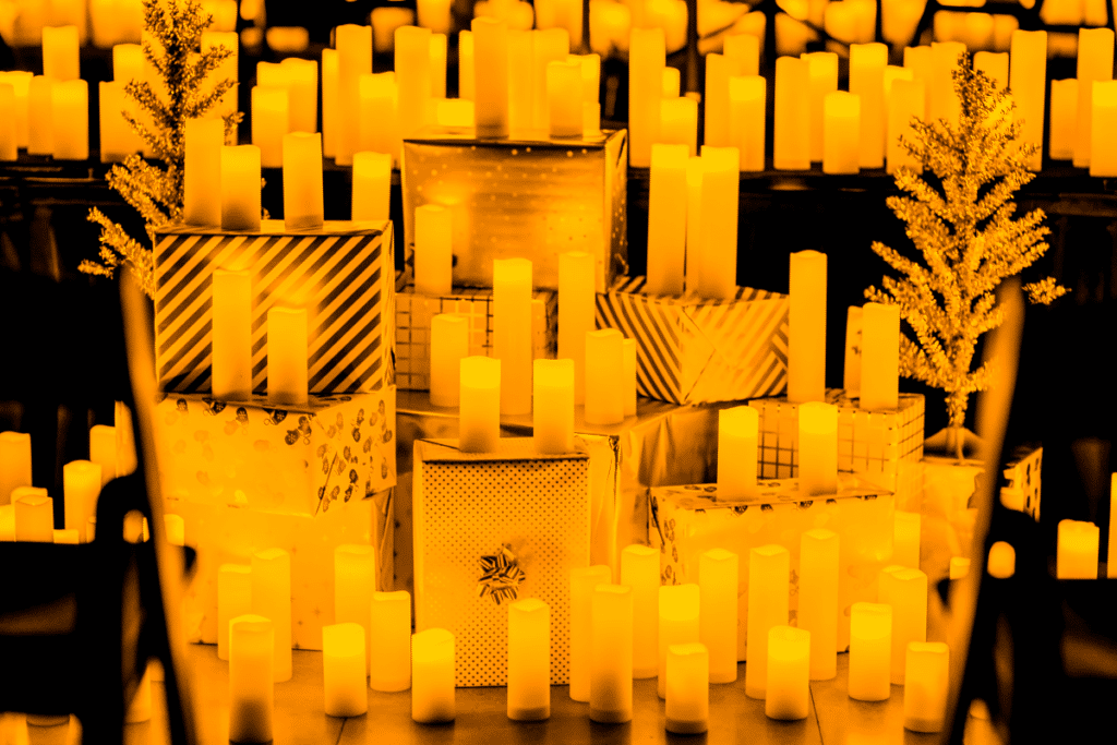 Countless candles sitting on top of wrapped presents at a Candlelight concert