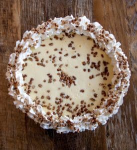 A New York cheesecake with cream and chocolate chips. 