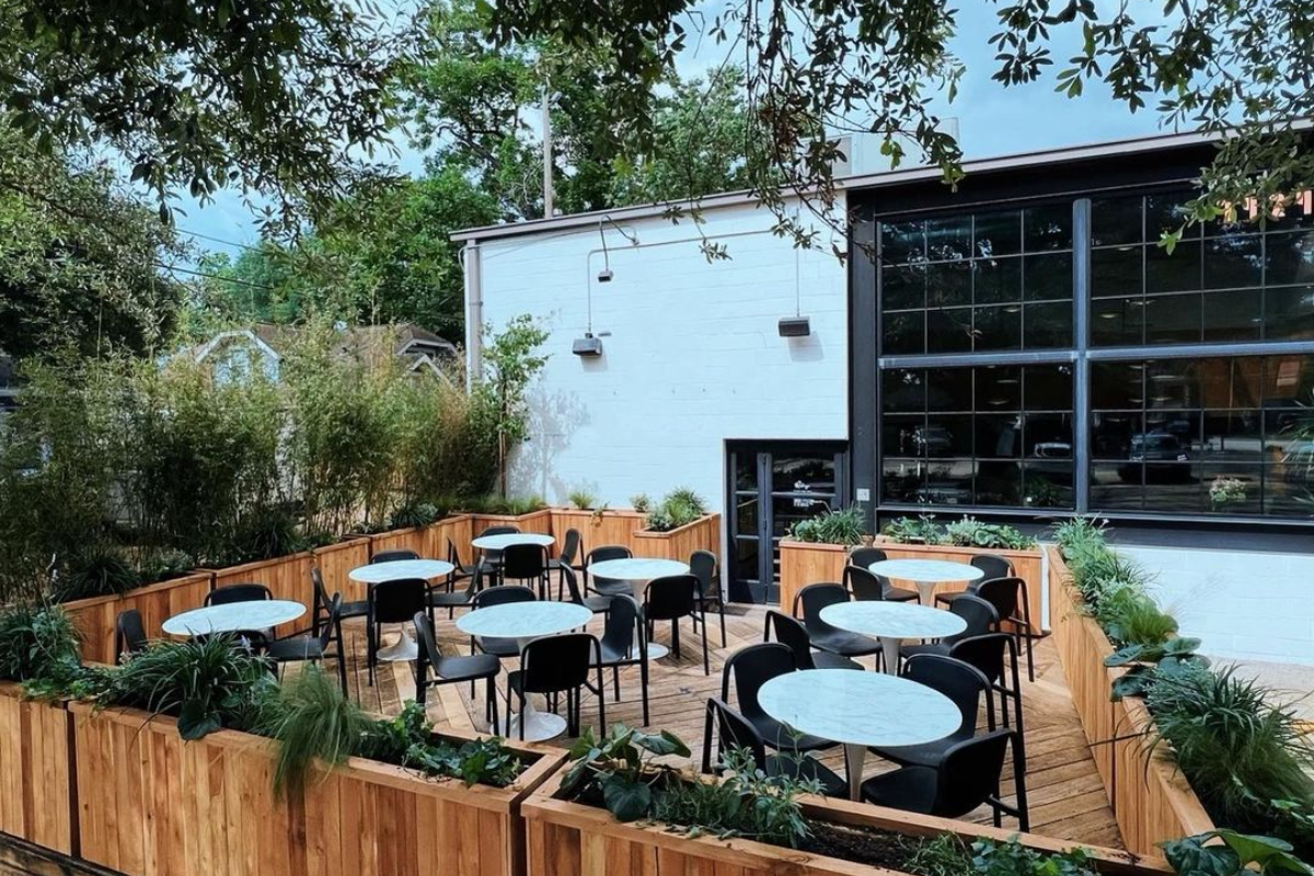 Image shows patio at Refuge cocktail bar and coffee shop in Houston.